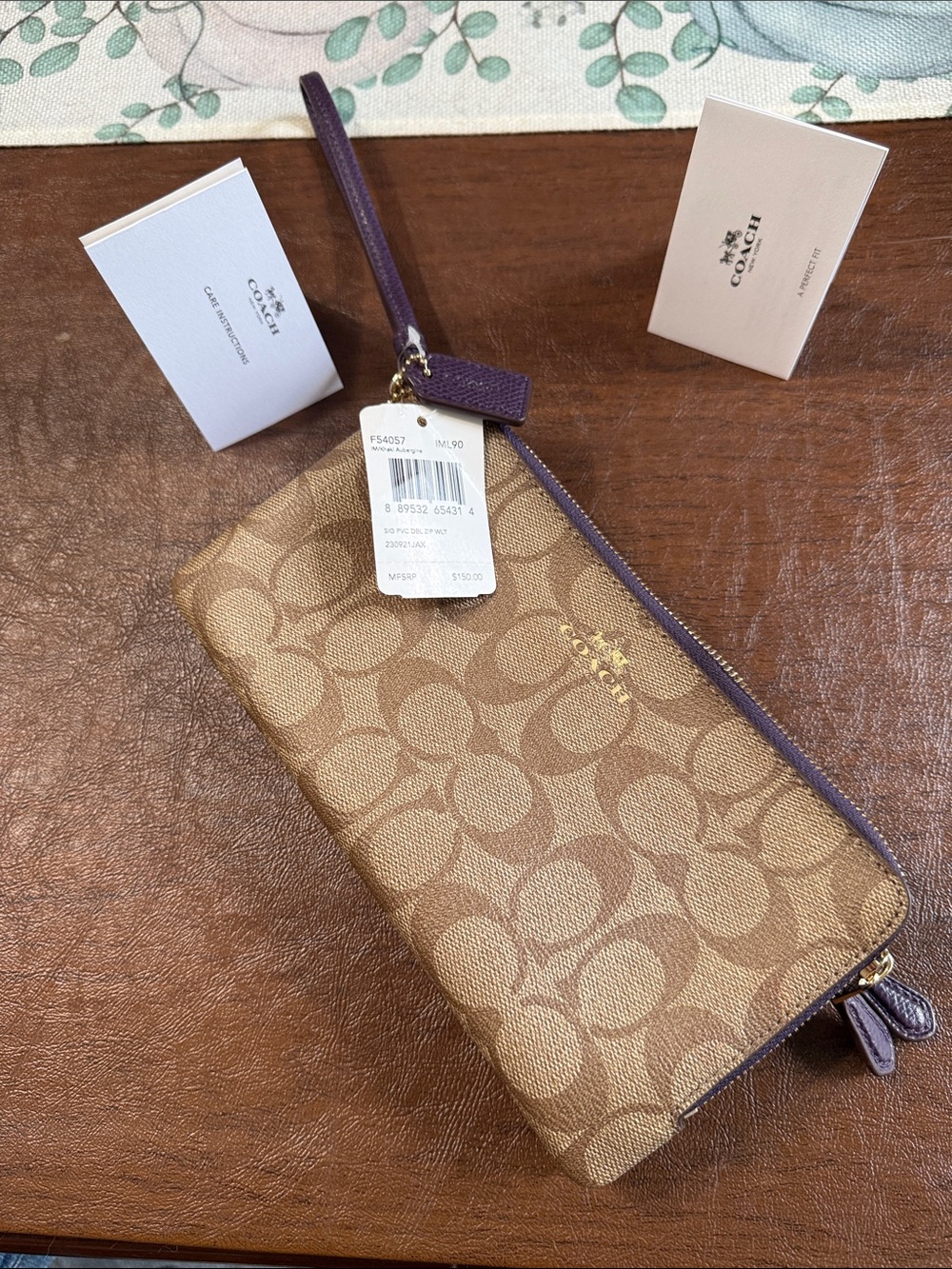 Coach Tan Signature Canvas Wristlet with Aubergine (deep purple) Trim. Beautiful